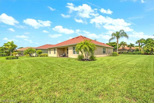 rear view of house with a lawn