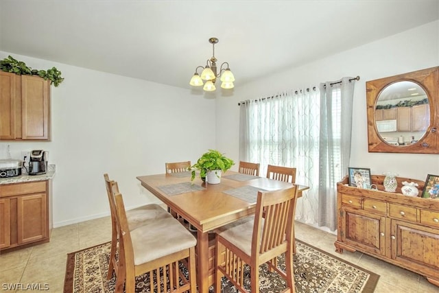 dining room with light tile patterned flooring and an inviting chandelier