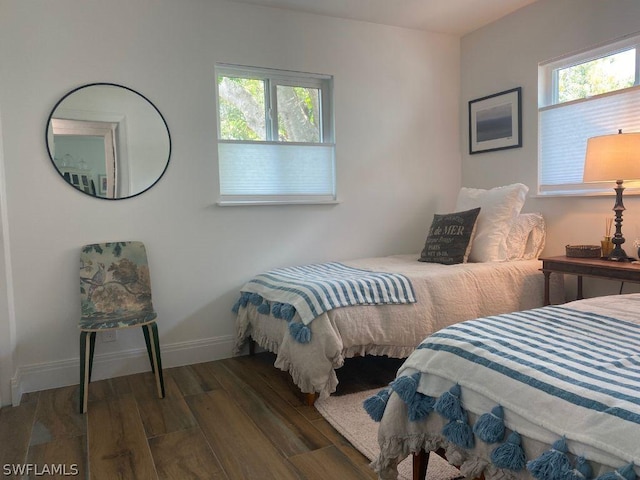 bedroom with dark hardwood / wood-style floors