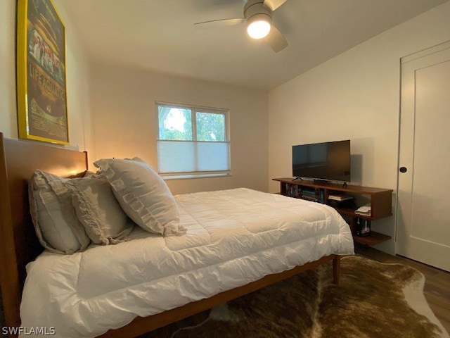 bedroom with hardwood / wood-style flooring, ceiling fan, and lofted ceiling