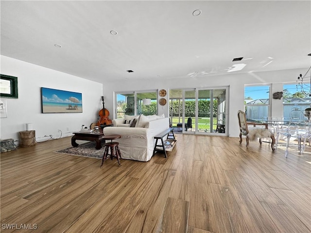 bedroom with access to exterior and light hardwood / wood-style floors