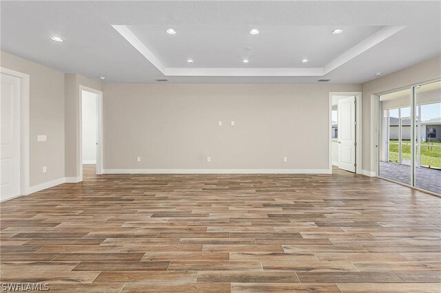 spare room with a tray ceiling