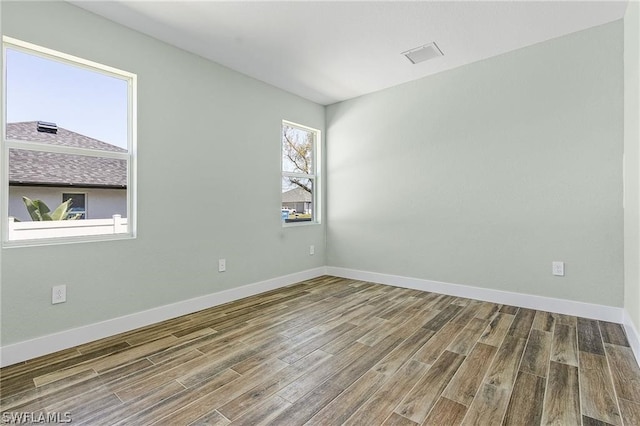 unfurnished room featuring hardwood / wood-style floors