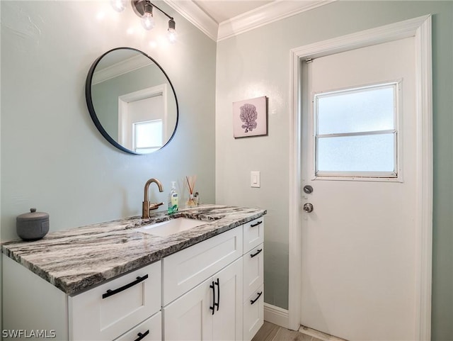 bathroom featuring vanity, crown molding, and wood-type flooring