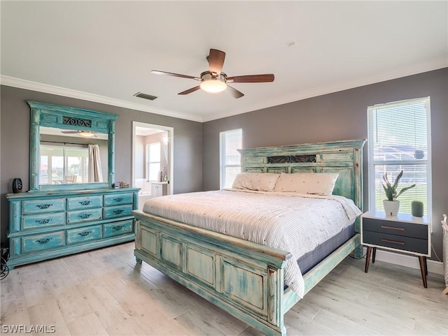 bedroom featuring multiple windows, crown molding, and light hardwood / wood-style floors