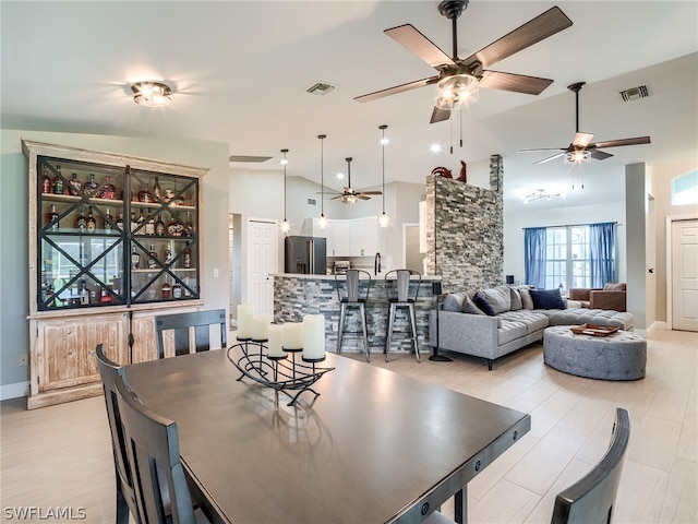 dining space featuring vaulted ceiling and ceiling fan