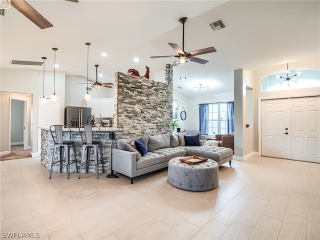 living room with light hardwood / wood-style flooring, ceiling fan, and high vaulted ceiling