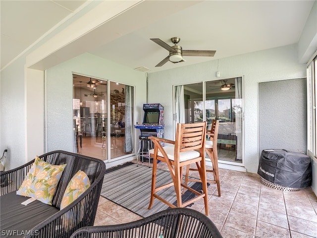 sunroom featuring ceiling fan