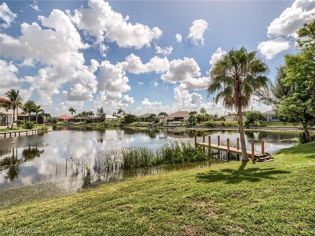 dock area featuring a water view and a yard