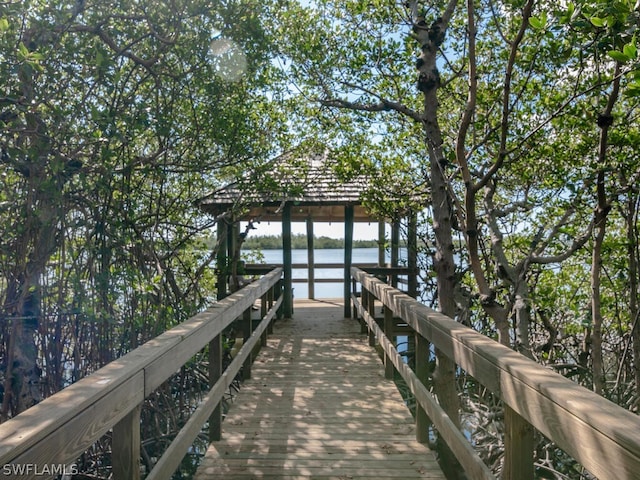 view of dock featuring a gazebo and a water view