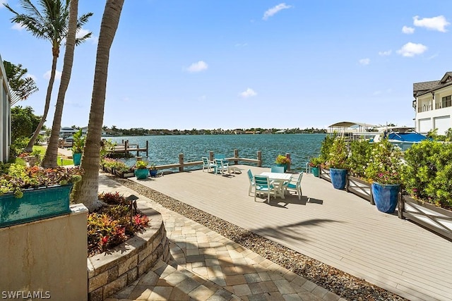 view of patio / terrace with a water view and a dock