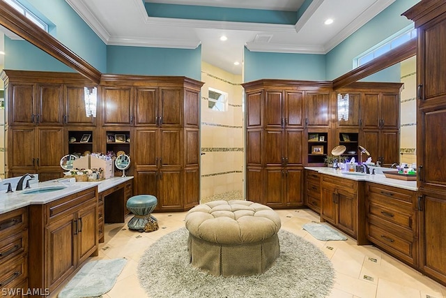 bathroom featuring a raised ceiling, tile patterned flooring, vanity, and ornamental molding