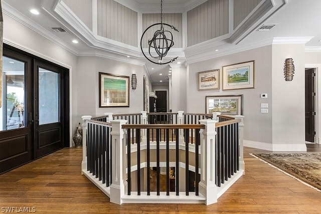 hall with french doors, an inviting chandelier, wood-type flooring, and ornamental molding