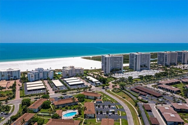 drone / aerial view featuring a water view and a beach view