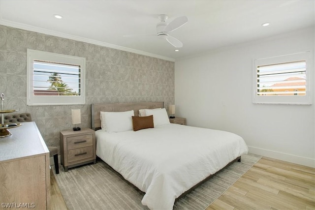 bedroom featuring crown molding, light hardwood / wood-style floors, and ceiling fan