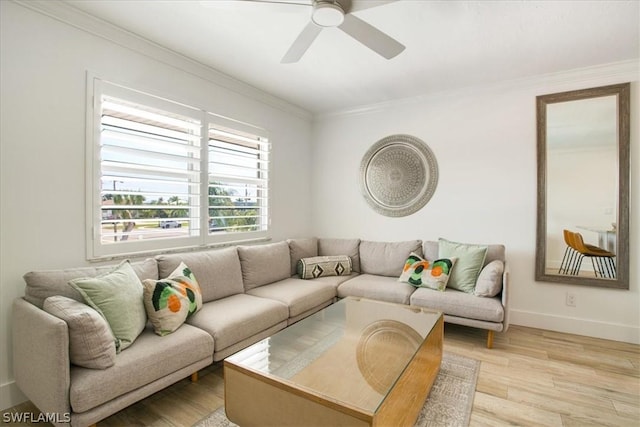 living room featuring ceiling fan, ornamental molding, and light hardwood / wood-style flooring