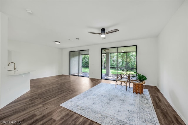 interior space featuring ceiling fan and dark hardwood / wood-style flooring