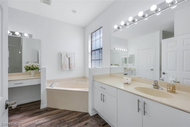 bathroom featuring shower with separate bathtub, vanity, and hardwood / wood-style flooring