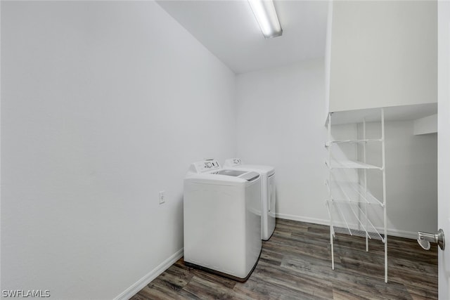 clothes washing area featuring washing machine and clothes dryer and dark wood-type flooring