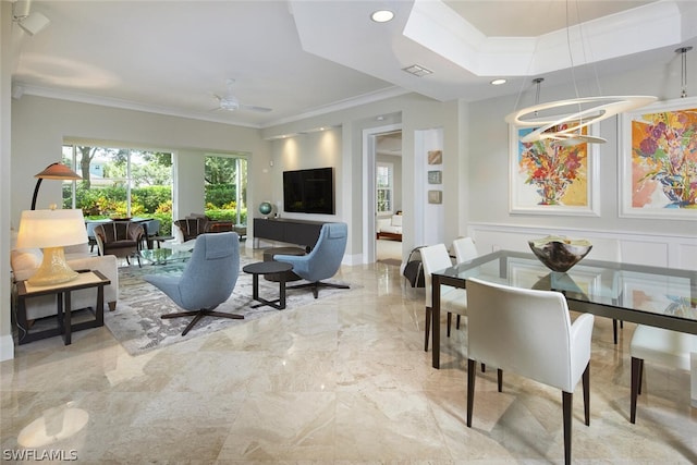 living room with ornamental molding and ceiling fan