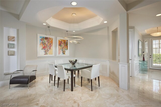 dining area featuring a tray ceiling