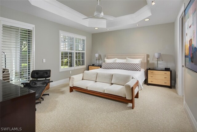 carpeted bedroom featuring crown molding, a raised ceiling, and ceiling fan