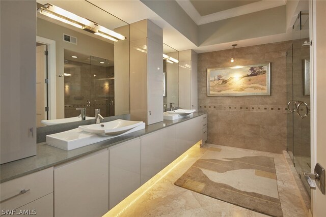 bathroom featuring vanity and a shower with shower door