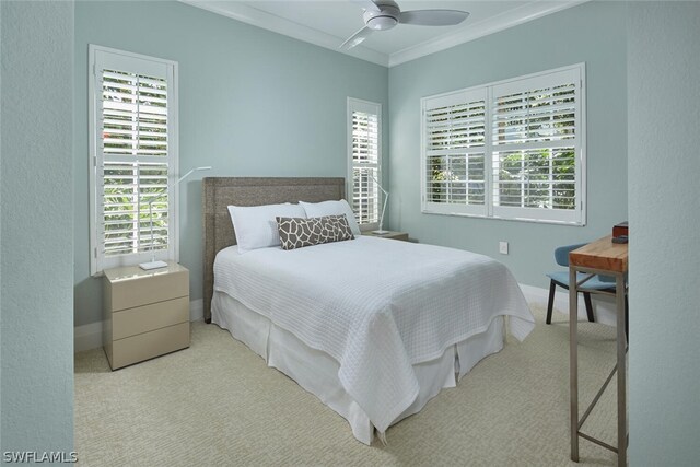 bedroom featuring crown molding, ceiling fan, and light carpet