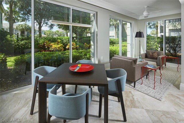 sunroom / solarium featuring ceiling fan