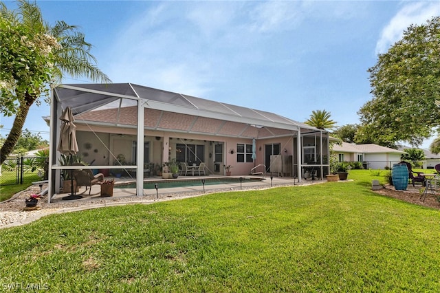 rear view of property featuring a lanai, a patio area, and a yard