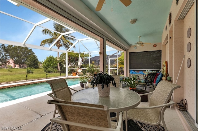 sunroom featuring ceiling fan