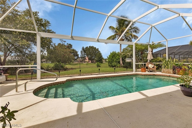 view of swimming pool featuring a patio area and glass enclosure