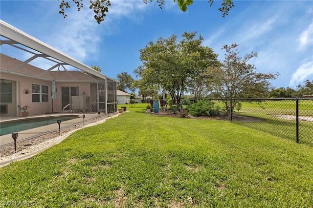 view of yard with glass enclosure and a fenced in pool