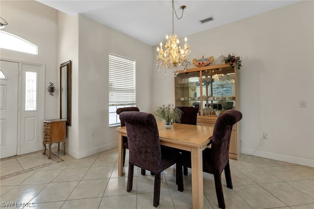 tiled dining area featuring a chandelier