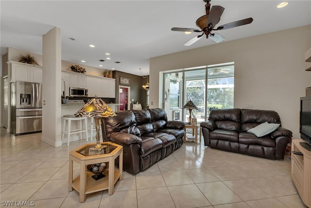 living room featuring light tile patterned flooring and ceiling fan