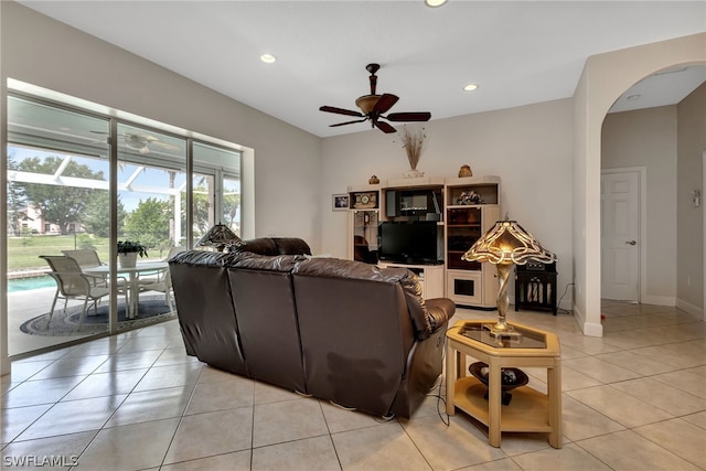 tiled living room featuring ceiling fan