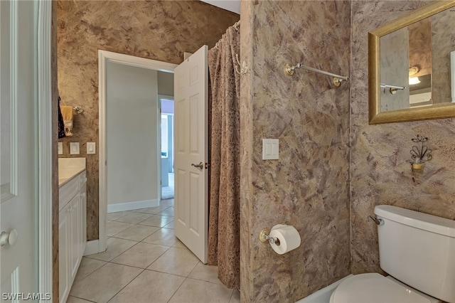 bathroom featuring tile patterned flooring, toilet, and vanity