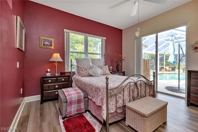 bedroom featuring hardwood / wood-style flooring, access to outside, and ceiling fan