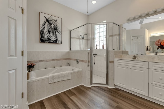 bathroom featuring vanity, plus walk in shower, and wood-type flooring