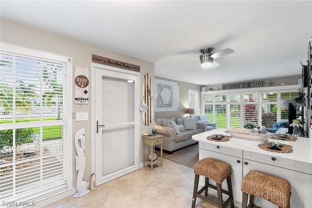 interior space featuring light tile patterned flooring and ceiling fan