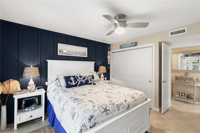 bedroom with light tile patterned flooring, ceiling fan, and a closet