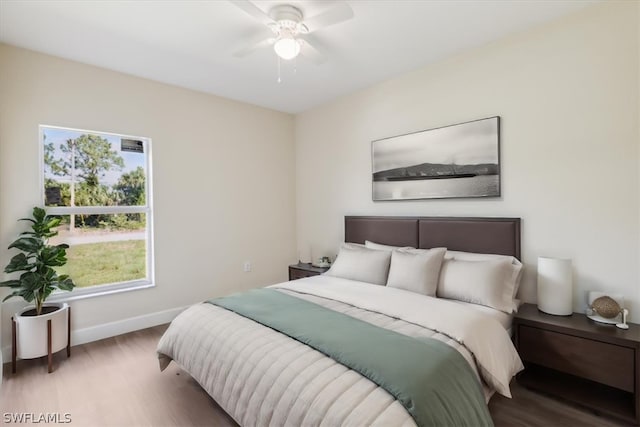 bedroom with ceiling fan and wood-type flooring