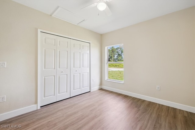 unfurnished bedroom featuring a closet, light hardwood / wood-style flooring, and ceiling fan