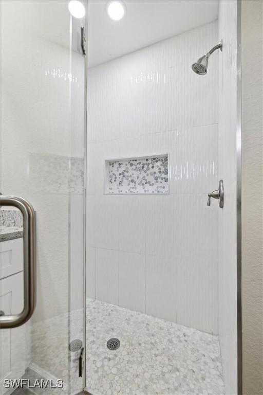 bathroom with a shower with shower door