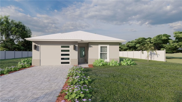 view of front of house featuring a garage and a front lawn