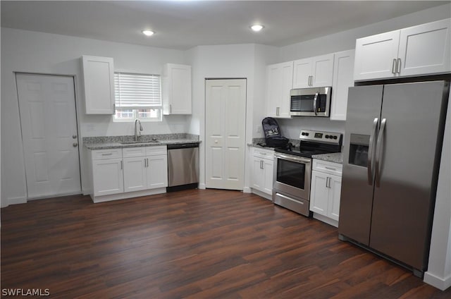 kitchen with sink, stainless steel appliances, dark hardwood / wood-style floors, and white cabinets