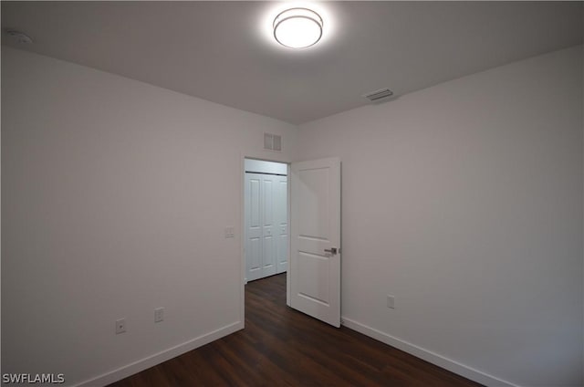 spare room featuring dark hardwood / wood-style flooring