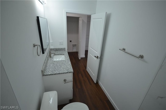 bathroom featuring vanity, hardwood / wood-style flooring, and toilet