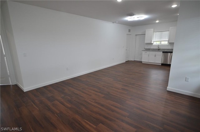 unfurnished living room with dark hardwood / wood-style floors and sink