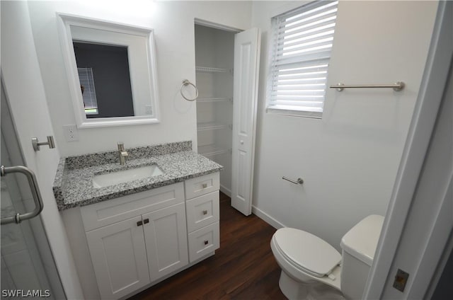 bathroom featuring vanity, toilet, and hardwood / wood-style floors